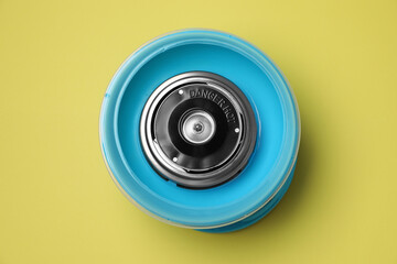 Portable candy cotton machine on yellow background, top view