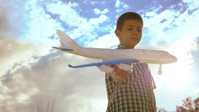 Evening Aspirations: Boy Playing with Toy Plane, Dreaming of Becoming a Pilot
