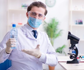 Young male chemist experimenting in lab