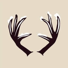 Obraz premium Snow covered deer horns on beige background