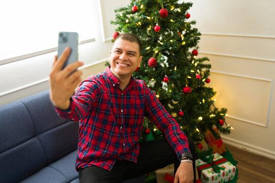 Handsome man with a santa hat on christmas taking a selfie