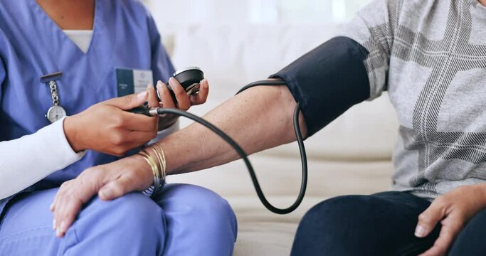 Nurse, hands and blood pressure test in home, check or healthcare for wellness of woman. Hypertension, caregiver and medical exam of patient with sphygmomanometer, monitor heart pulse or consultation