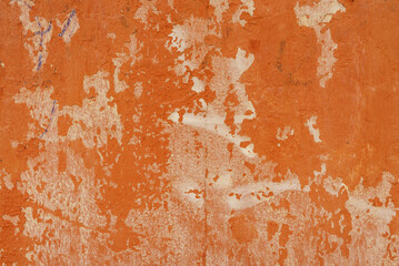 A cement wall painted red with the paint worn away. Vector cement texture background