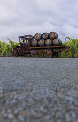 Vintage truck with wine barrels in a Vineyard on a cloudy day