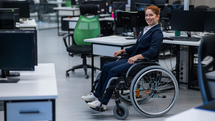 Obraz premium Caucasian woman wheelchair in open space office.