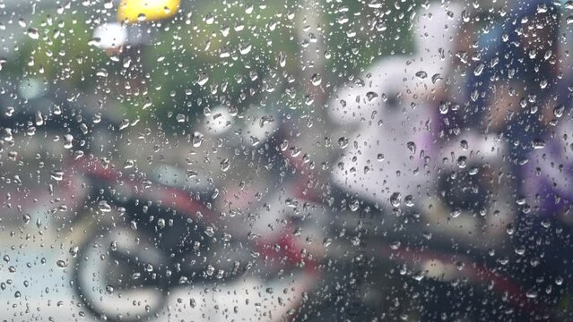 Rain Drops Falling down on background view, High quality photo of Rain on Window Sky Drops, Close up Slow Rain, Rainy day, Heavy Rainfall. Raining in car mirrors on traffic.