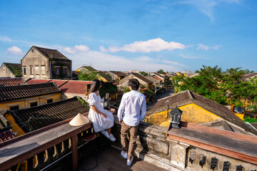 Young couple tourist looking at Hoi An Ancient town in Vietnam, Travel concept