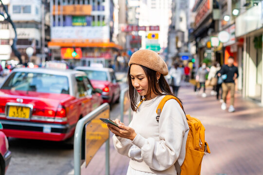 Young woman traveler walking in the Mong Kok in Hong Kong, Mong Kok is one of the major shopping areas in Hong Kong