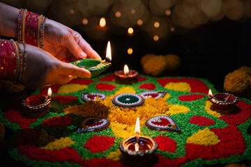 Clay diya lamps lit during diwali celebration, Diwali, or Deepavali, is India's biggest and most important holiday.