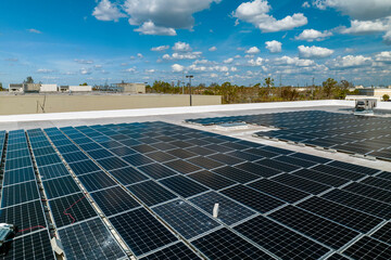 Photovoltaic solar panels destroyed by hurricane strong wind mounted on industrial building roof for producing green ecological electricity. Consequences of natural disaster in Florida