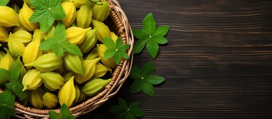 Organic star fruit from an Asian farm in a wicker basket on a rustic wooden table ideal for writing With copyspace for text