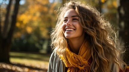 a beautiful young woman smiling in the autumn park