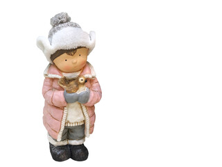 Cute decoration for the Christmas tree. A beautiful figurine of a little boy in warm clothes. who holds a bird in his hands on a white isolated background. Holiday, celebration, New Year, Noel concept