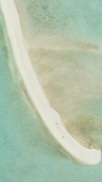 Aerial view of sandy beach and coral reef. Sandbar and atoll. Timba Timba islet. Tun Sakaran Marine Park. Borneo, Sabah, Malaysia.