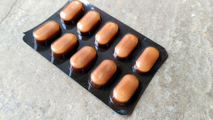 SOME PILLS PUT ON A STONE SURFACE