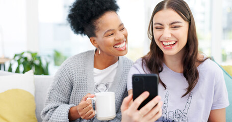 Coffee, phone and girl friends on a sofa talking, bonding and networking on social media or mobile app. Happy, conversation and young women scroll on cellphone with latte in living room of apartment.