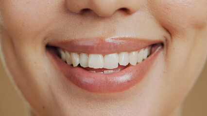 Naklejka premium Woman, smile and closeup in studio for dental wellness, beauty and change with cosmetics by background. Girl, teeth whitening and happy for clean mouth, health and zoom for oral care with hygiene