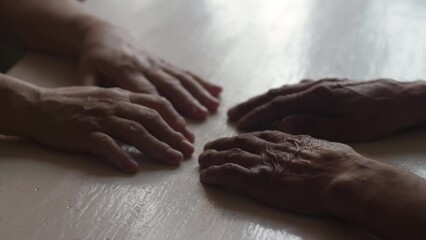 a married couple of pensioners are sitting opposite each other. husband and wife 70 -79 years old, marital relationships, emotions of old people in the family, real elderly married couple