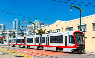 Municipal light rail tram on 4th street in San Francisco - California, United States - obrazy, fototapety, plakaty