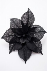 a black flower with a pearl on it