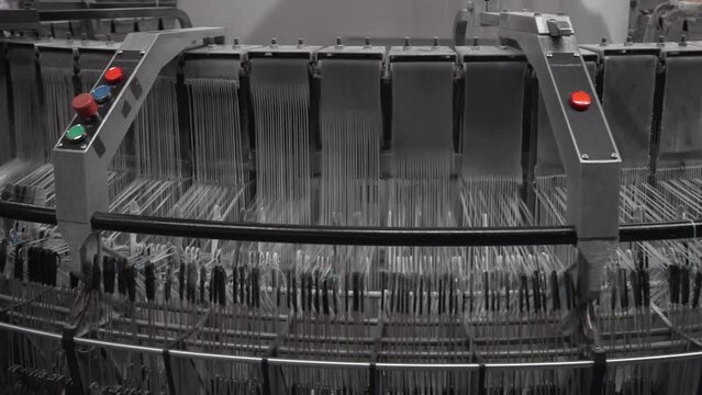 Production of polypropylene yarn for making bags. plastic polypropylene flat yarn bobbins loaded on circular weaving loom machine 
