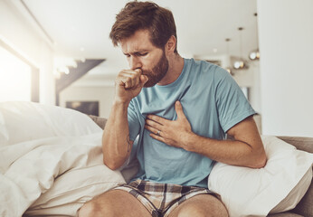 Sick, coughing and man on a sofa with chest pain, tuberculosis or influenza at home. Asthma, anxiety and male person with breathing trouble in living room with covid, pneumonia or lung virus - obrazy, fototapety, plakaty