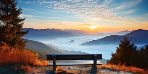 a bench overlooking a valley with mountains and clouds