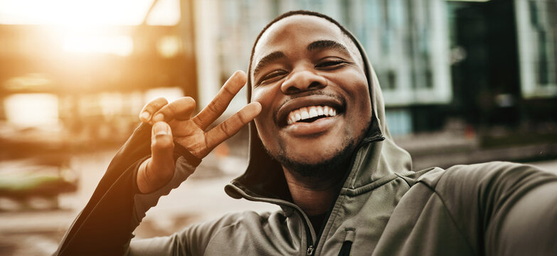 Happy black man, face and peace sign for selfie, fitness or photography after running or exercise in city. Portrait of African male person smile with emoji for photograph, picture or memory in town