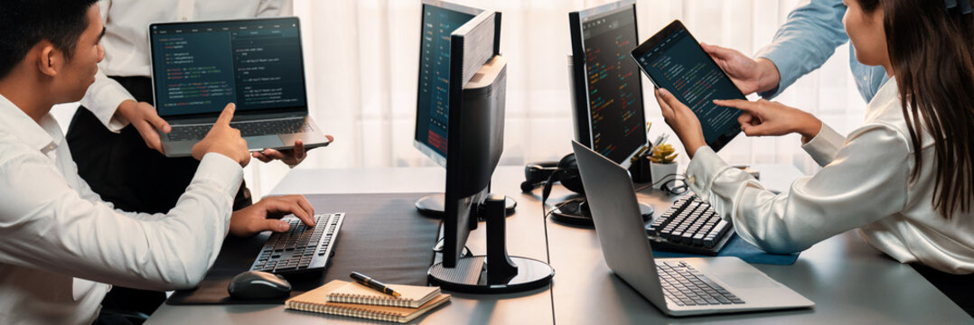 Software development team working together in office, coding script display on computer monitor. Programmer and software engineer working in tech developer company. Trailblazing