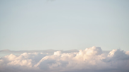 Beautiful blue sky and pearl fluffy cloud with sunrise in the morning. Natural background or atmosphere wallpaper