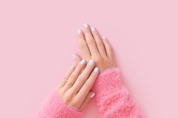 Womans hands with white manicure on pink background - obrazy, fototapety, plakaty