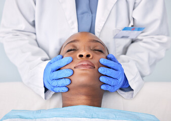 Naklejka premium Massage, hands and a skin analysis on a black woman from a doctor for healthcare or dermatology. Spa, wellness and an African patiennt with a facial rub from a medical employee for a cleaning