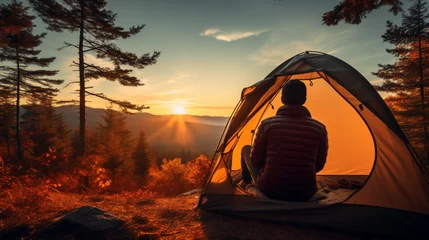 Rolgordijnen Traveler holding relaxing inside a orange tent © Rimsha