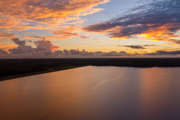Naklejka na ściany i meble Aerial view of a lake at sunset