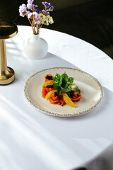 salad with fresh salmon, orange and caviar, restaurant menu