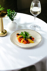salad with fresh salmon, orange and caviar, restaurant menu