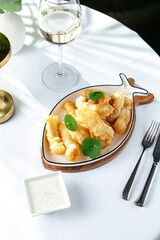 shrimp fried in batter on a white plate in the shape of a fish o