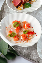 seafood appetizers on plates served in a bowl with ice