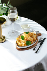 shrimp fried in batter on a white plate in the shape of a fish o