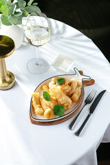 shrimp fried in batter on a white plate in the shape of a fish o