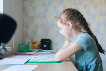 A schoolgirl doing her homework at home