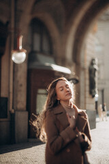 Fototapeta premium A young woman walks in the morning in sunny Prague