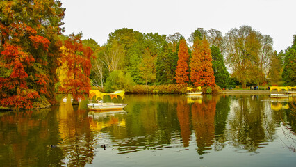 Mannheim, Germany. Park lake, boats and pelicans. Panoramic view over Luisen city park at sunset...