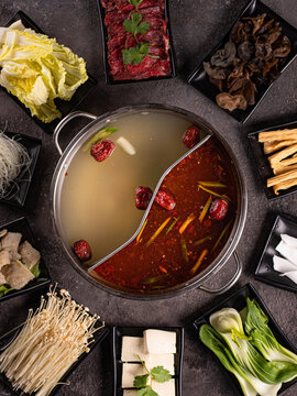 delecious asian bouillion with a lot of ingrediens around it. View from above. Chinese cuisine, ingredient for hotpot