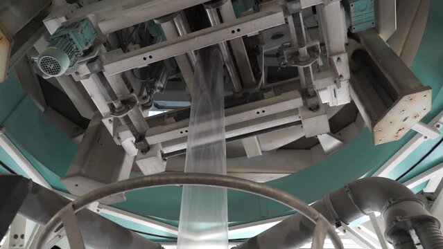 The operation of automatic plastic bag production machine. Blown film extrusion plastic bag making machine. Plastic Polyethylene metallocene blow film machine with oscillation device 
