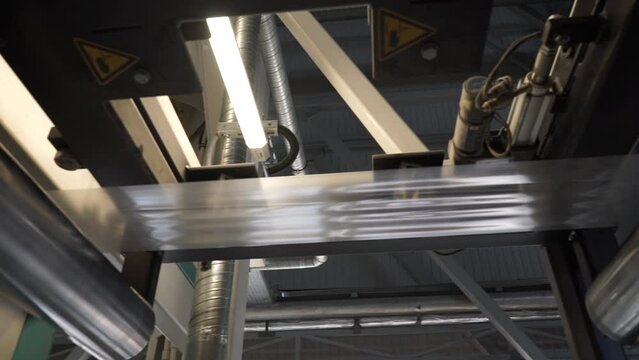 Automatic polyethylene plastic bag production machine with lighting effect.  Industrial line for the production of plastic packaging film. Factory for the production of packaging materials
