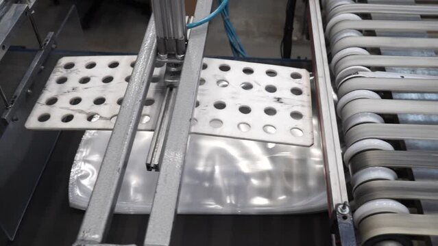 Automatic polyethylene plastic bag production machine with lighting effect. product packaging concept. Plastic bag manufacturing process.
