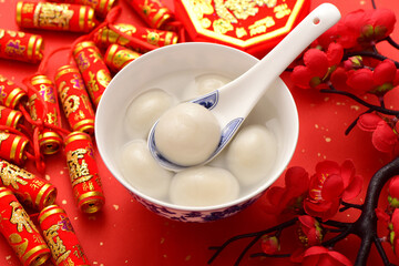 A bowl of rice dumpling is placed on the red festive background of China-Chic Chinese style. The Chinese meaning in the picture is: luck