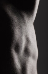 Fitness, man and torso with closeup in studio for wellness, stomach and body on dark background....