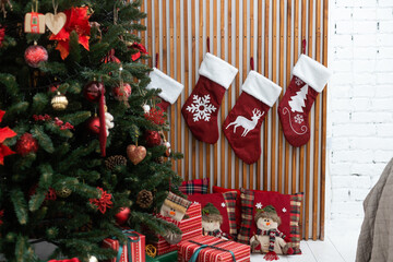 Christmas socks with gifts hanging on the wall